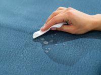 Water drops on waterproof textile material - short depth of field. Waterproof fabric on sofa